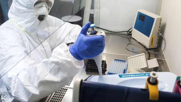 Сотрудник лаборатории проводит тесты на коронавирусную инфекцию - Sputnik Latvija