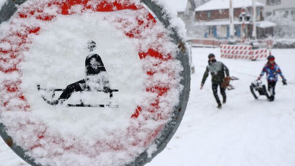 Люди на санках во время снегопада в Цюрихе - Sputnik Latvija
