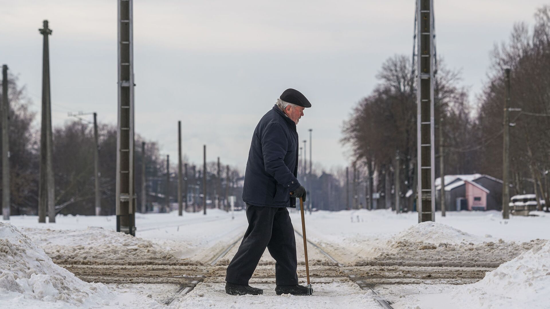 Пожилой мужчина переходит через железнодорожные пути - Sputnik Латвия, 1920, 03.12.2021