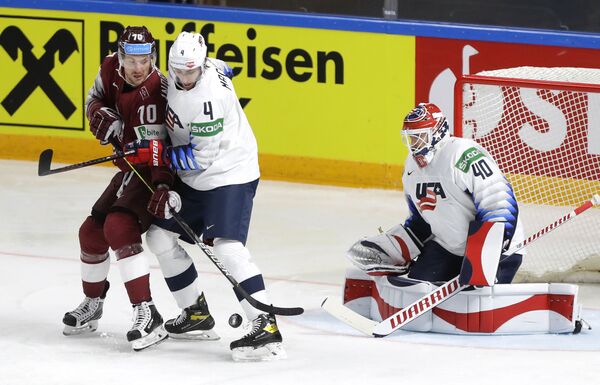 Латвийский игрок Лаурис Дарзиньш борется за шайбу с Коннором МакКи из США в матче группового этапа чемпионата мира по хоккею - 2021 между сборными США и Латвии - Sputnik Латвия