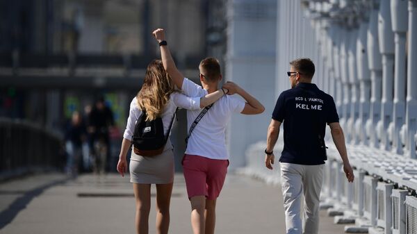 Молодые люди идут по Крымскому мосту в Москве - Sputnik Латвия