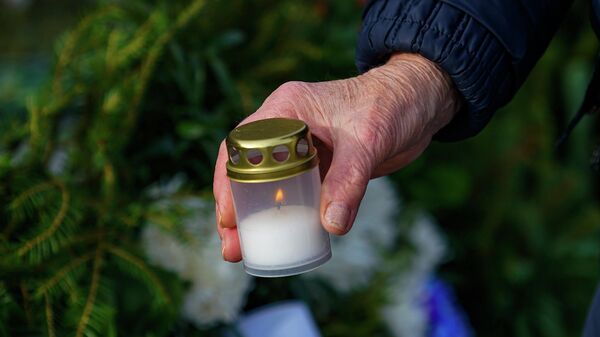 Свеча в руках женщины. Церемония возложения цветов к памятнику Освободителям Риги 23 февраля - Sputnik Латвия