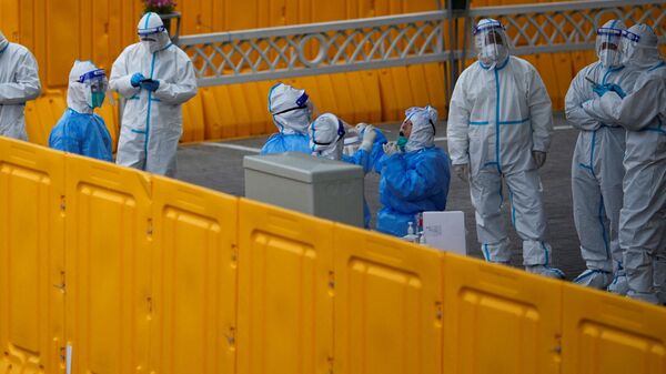 Полицейские и сотрудники проходят тестирование на коронавирус внутри зоны, закрытой из-за коронавирусной болезни в Шанхае - Sputnik Латвия