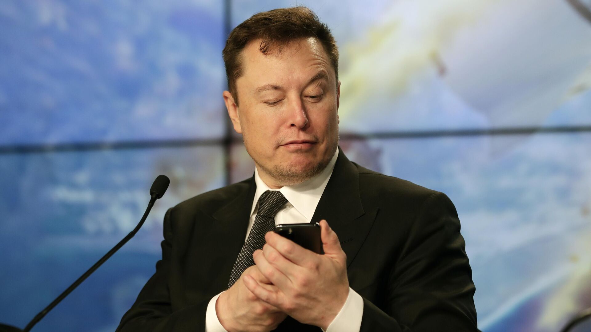Основатель SpaceX Илон Маск шутит с журналистами, делая вид, что ищет ответ на вопрос по мобильному телефону во время пресс-конференции - Sputnik Латвия, 1920, 08.09.2023