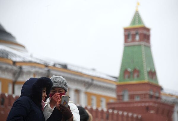 Иностранные туристы в защитных масках на Красной площади в Москве Иностранные туристы в защитных масках на Красной площади в Москве - Sputnik Латвия