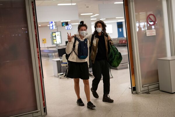  Пассажиры рейса из Амстердама в защитных масках прибывают в международный аэропорт в Афинах, Греция - Sputnik Латвия