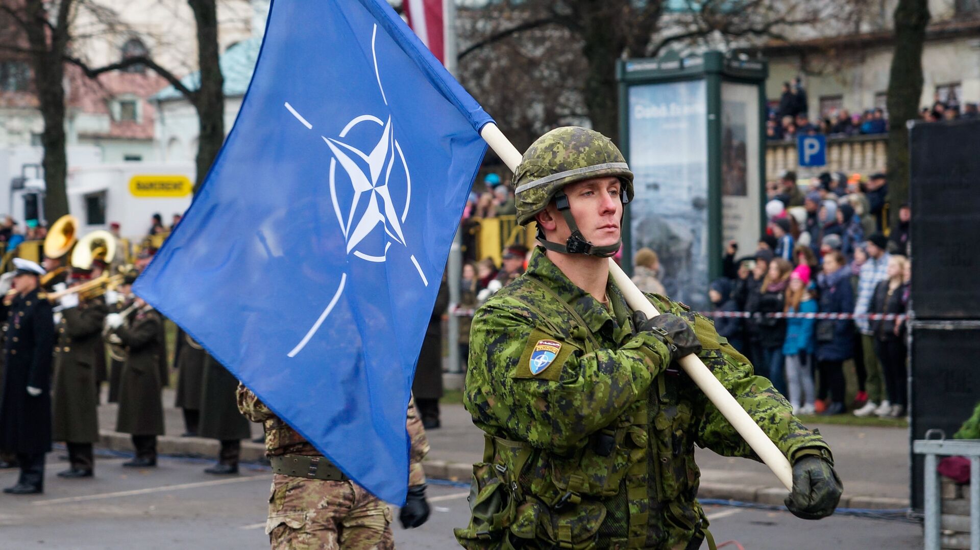 Военнослужащий Канады несет флаг НАТО на военном параде в Риге - Sputnik Латвия, 1920, 30.11.2021