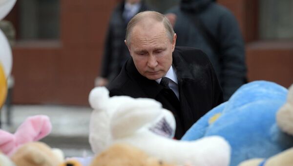 Президент РФ Владимир Путин возлагает цветы к стихийному мемориалу у торгового центра Зимняя вишня в Кемерово, где случился пожар - Sputnik Латвия