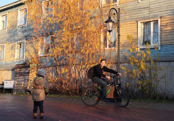 Юноша на велосипеде возле деревянного дома в Салехарде - Sputnik Латвия